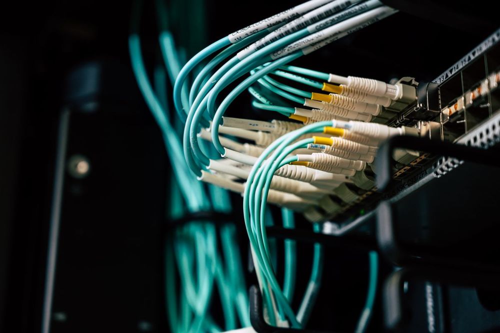 Fiber patch cabling connected to rack-mounted network equipment