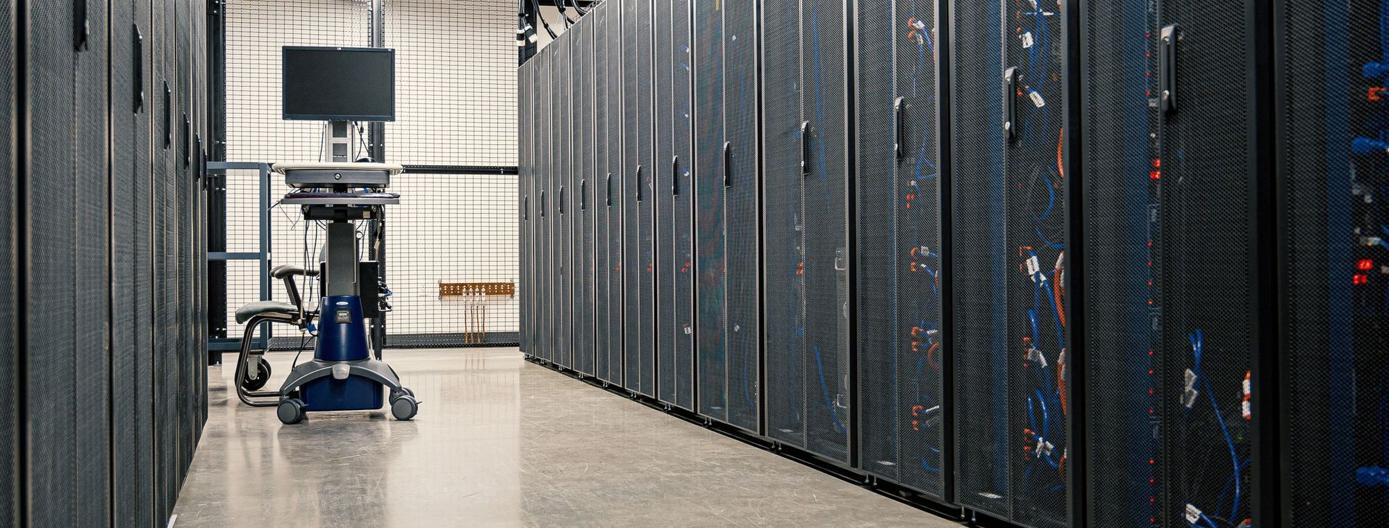 Data center corridor with an equipment cart between rows of server cabinets